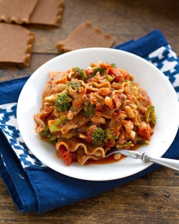 Broccoli and white bean lasagna on a plate with a fork.