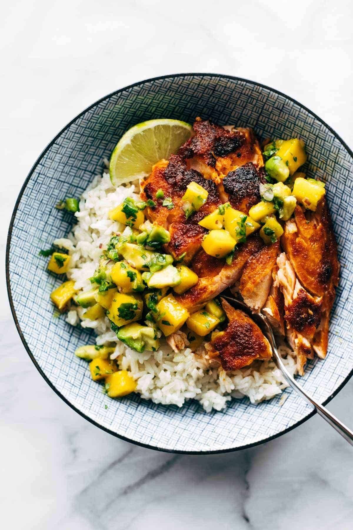 BBQ salmon in a bowl with rice and mango salsa.