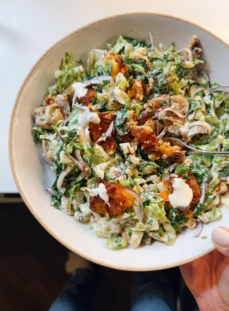 Smashed potato salad in a bowl.