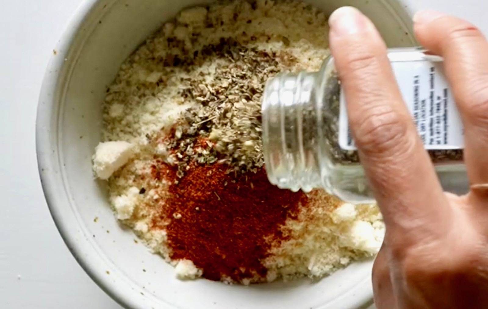 Mixing spices in a bowl.