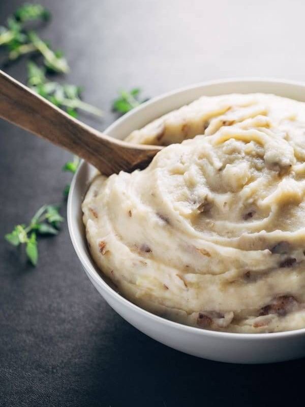 Easiest Garlic Mashed Potatoes - made entirely in the bowl of a slow cooker for easy prep and clean up! And that roasted garlic flavor - YUM.