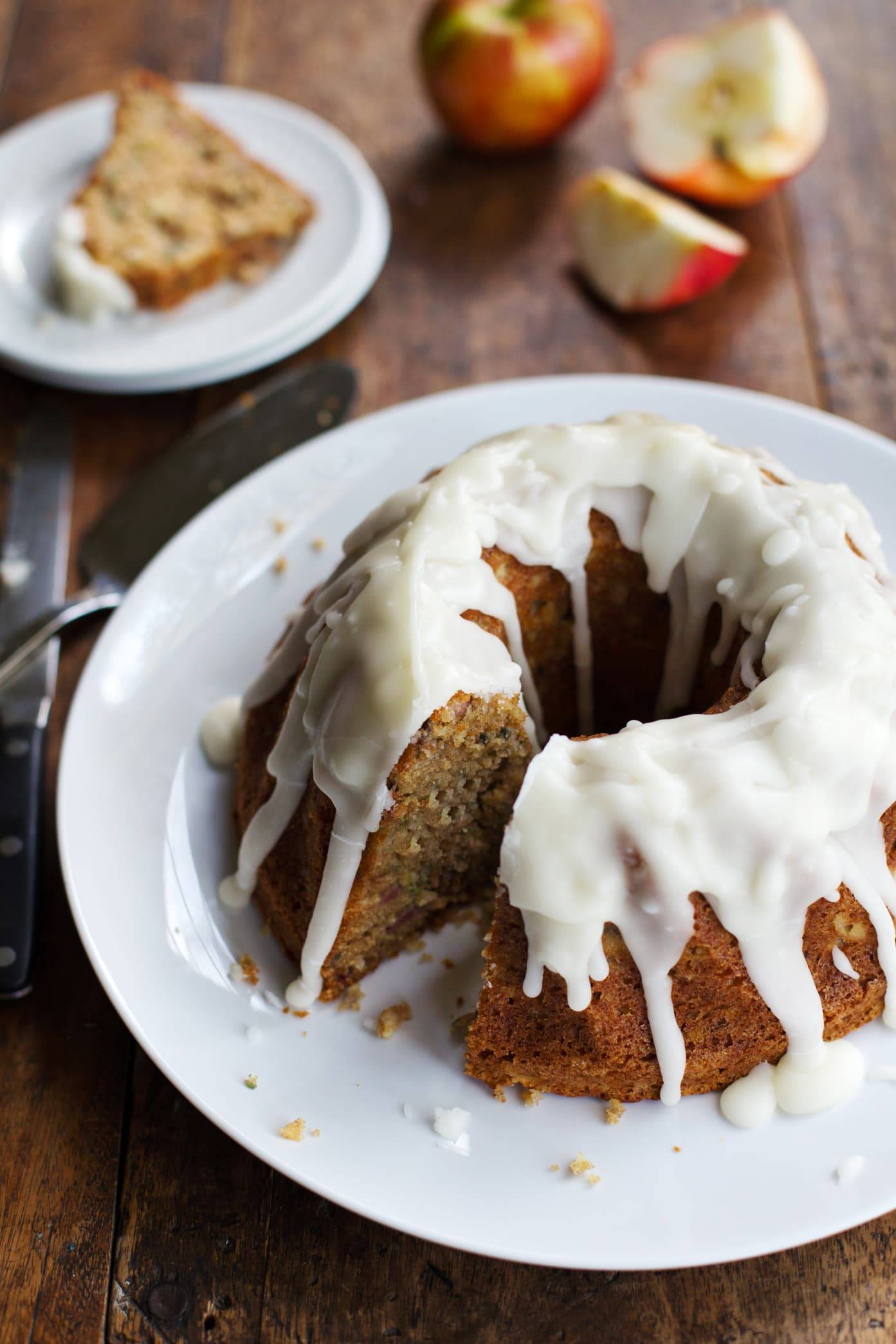 Honey apple bundt cake with glaze on a plate.