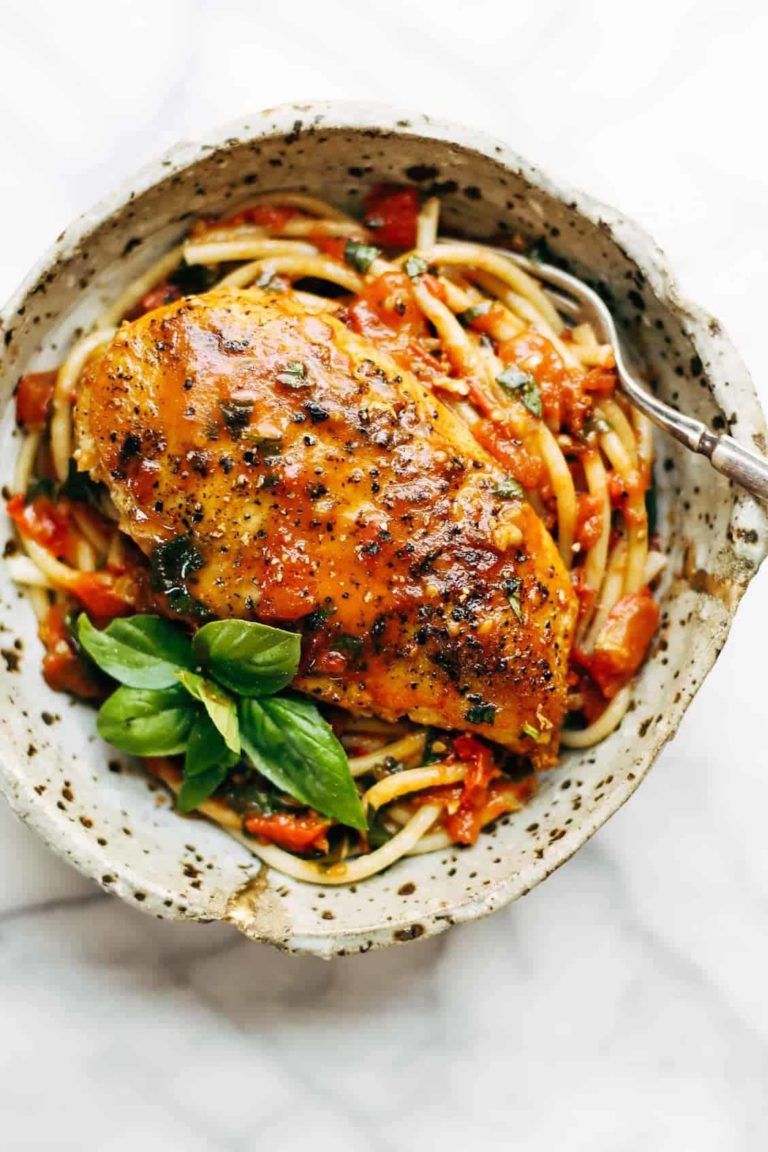 Garlic Basil Chicken in a bowl with pasta and basil.